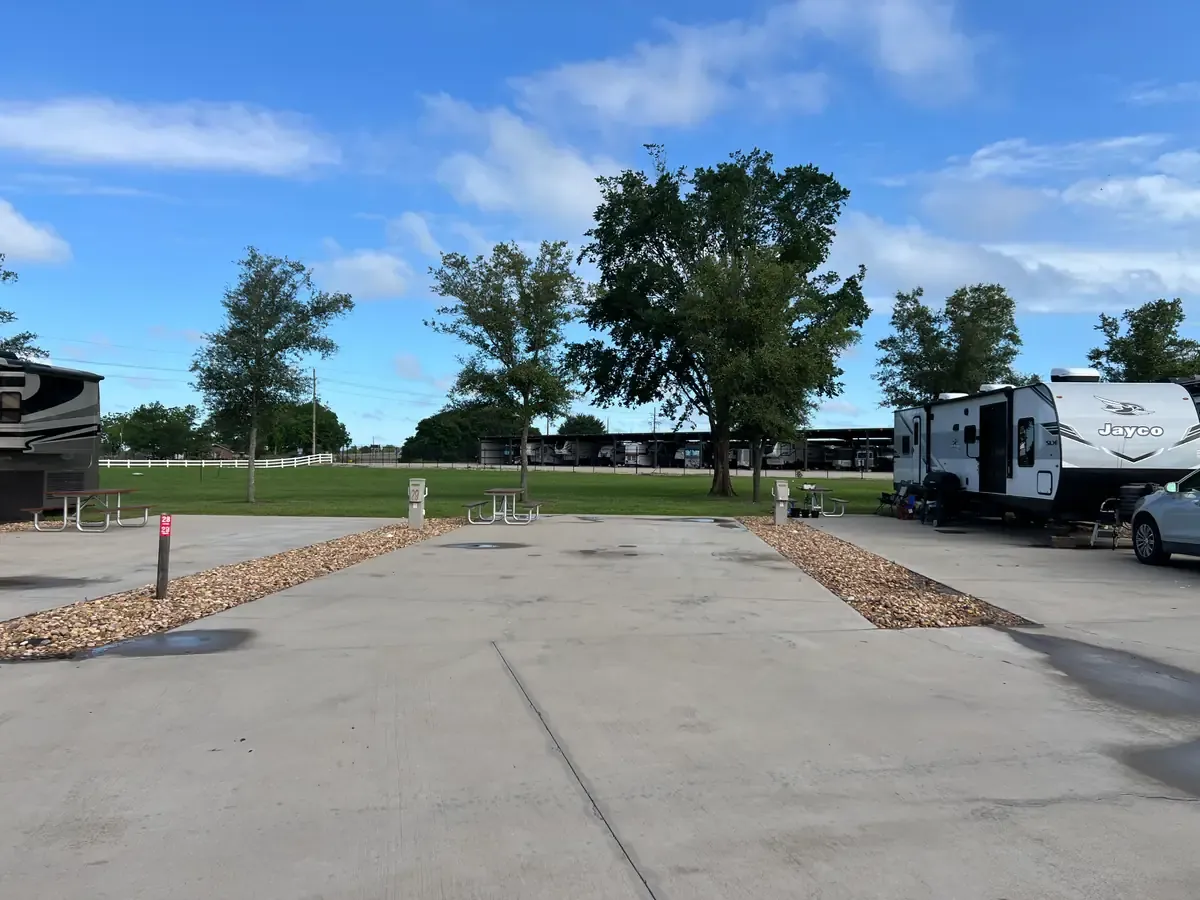 Empty RV parking space on concrete and a picnic table